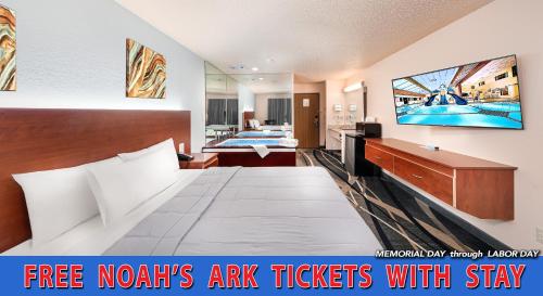 a hotel room with a large bed and a tv at Grand Marquis Waterpark Hotel & Suites in Wisconsin Dells