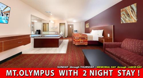 a hotel room with a bed and a couch at Grand Marquis Waterpark Hotel & Suites in Wisconsin Dells