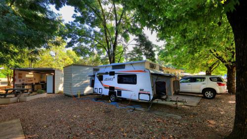 an rv is parked next to a garage at Bright Valley Holiday Park in Bright