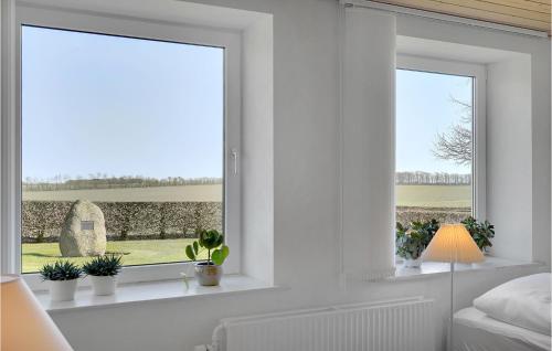 a bedroom with a window with potted plants at 3 Bedroom Beautiful Apartment In Kibæk in Kibæk