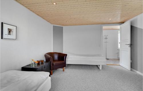 a bedroom with a bed and a desk and a chair at 3 Bedroom Beautiful Apartment In Kibæk in Kibæk