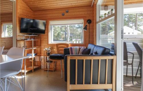 a living room with a couch and a tv in a house at Cozy Home In Nexø With Wifi in Neksø