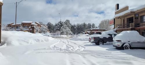 a street covered in snow with cars parked at CASTLE ROCK in Flagstaff