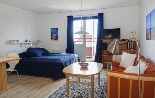 a living room with a bed and a table at Awesome Apartment In Gudhjem With Wifi in Gudhjem