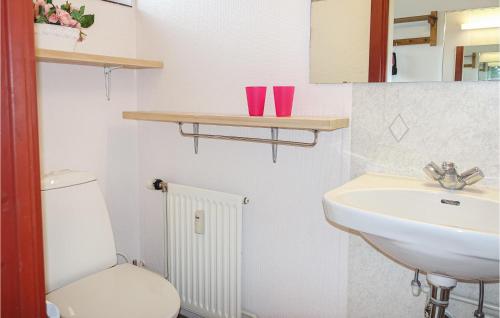 a bathroom with a white sink and a toilet at Awesome Apartment In Gudhjem With Wifi in Gudhjem