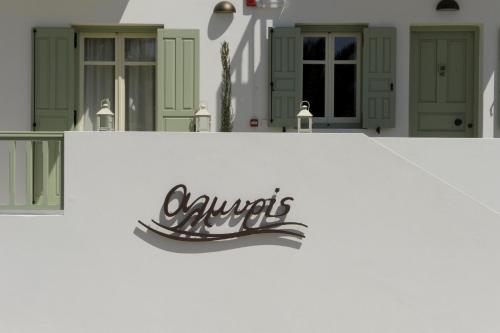 a sign on the side of a house at Almyris in Adamas