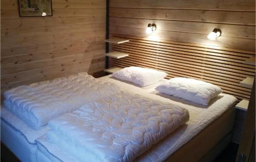 a large white bed with two pillows in a room at Lovely Home In Vetlanda With House Sea View in Vetlanda