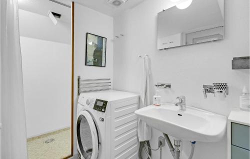 a white bathroom with a washing machine and a sink at Beautiful Home In Ribe With Wifi in Ribe