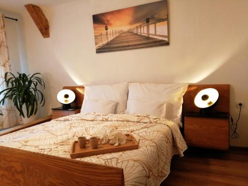 a bedroom with a bed with a wooden tray on it at Apartman Deluxe Cheb in Cheb