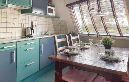 a kitchen with a wooden table with wine glasses on it at Beautiful Home In Chaam With Wifi in Chaam