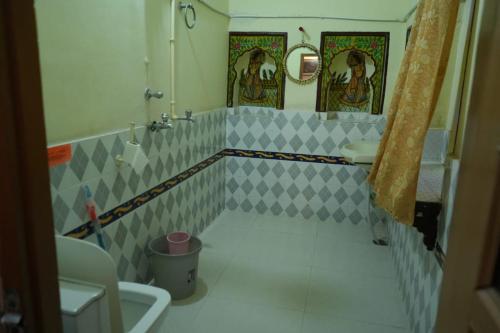 a bathroom with a toilet and a sink and a mirror at Kasera Paradise in Būndi