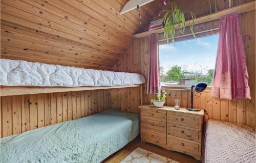 a bedroom with a bunk bed in a wooden cabin at Amazing Home In Esbjerg V With House Sea View in Esbjerg
