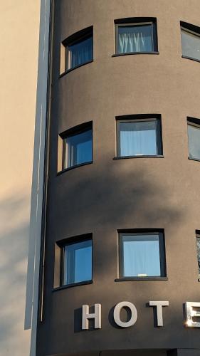 a building with a hotel sign on the side of it at Hotel Porta Palio in Verona