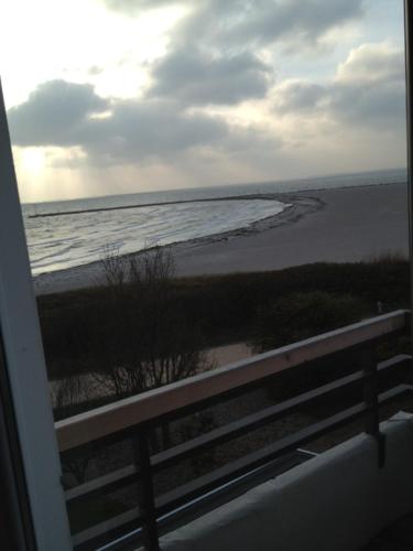 a view of the beach from a balcony at Strandhotel Bene in Burgtiefe auf Fehmarn 