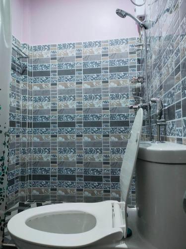 a bathroom with a toilet and a sink at Stella'z guesthouse in Siquijor