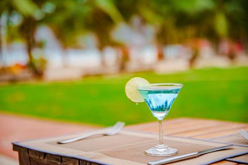a martini glass with a lime on a table at Thiên Tân Hotel in Con Dao