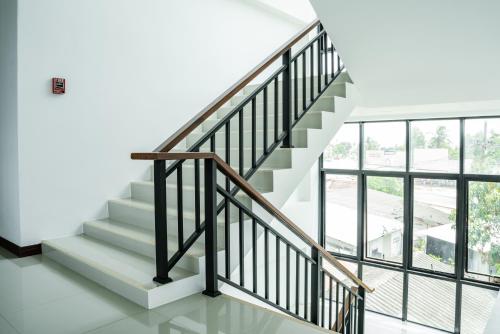 a staircase in a house with glass windows at Circle Inn Ao Nam Mao in Ao Nam Mao