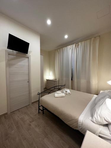 a bedroom with a bed with a television on the wall at Domo Achenza in Terralba