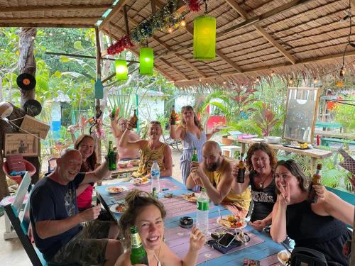 a group of people sitting around a table with drinks at Freedom home in Ko Chang