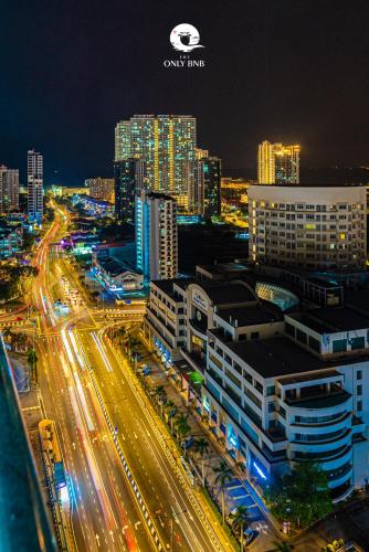 a city lit up at night with traffic on a highway at Large Family Seaview Suite 3 Rooms by The Only Bnb in Tanjong Tokong