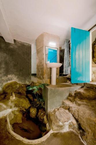 a bathroom with a sink in the middle of a room at River Edge Eco Resort in Kitulgala
