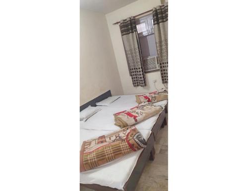 A bed or beds in a room at Hotel Prem Sagar, Agra Cantt
