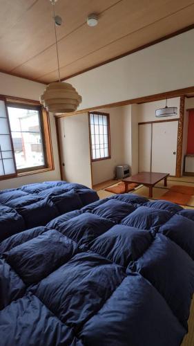 a large room with blue pillows on the floor at Baco Myoko Akakura in Myoko