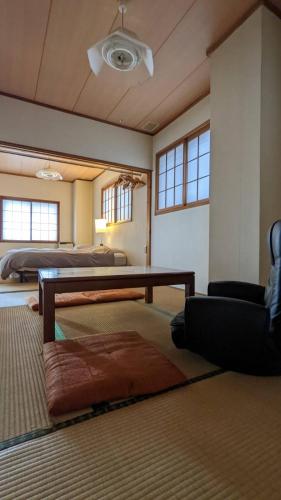 a living room with a table and a couch at Baco Myoko Akakura in Myoko
