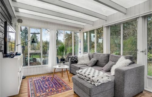 a living room with a couch and some windows at 2 Bedroom Lovely Home In Hemmet in Hemmet