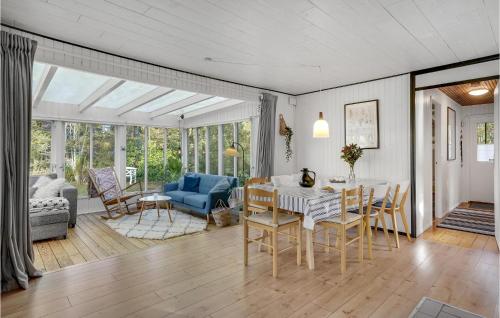 a dining room and living room with a table and chairs at 2 Bedroom Lovely Home In Hemmet in Hemmet