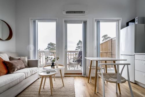 a living room with a couch and a table at New lakehouse - amazing sea view and private pier! in Stockholm