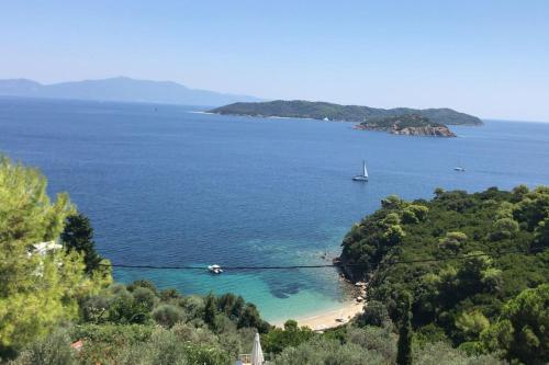 a view of a beach with a boat in the water at Villa Bounatsa with access to semi-private beach in Kanapitsa