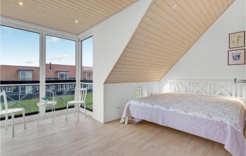 a bedroom with a bed and a large window at Stunning Home In Juelsminde With Wifi And 3 Bedrooms in Juelsminde