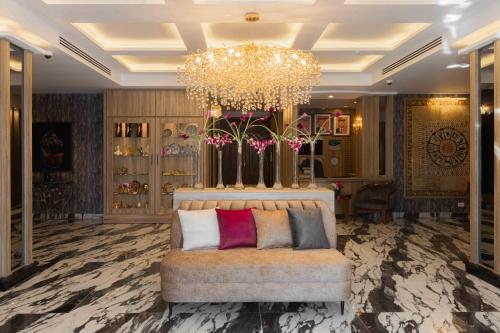 a living room with a couch and a chandelier at Amman Inn Boutique Hotel in Amman