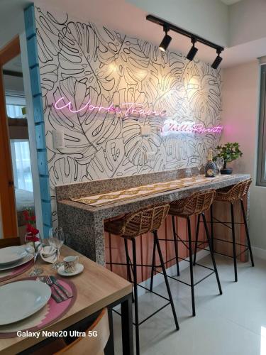 a bar with pink lights on a wall at Holiday Escape Philippines in Manila