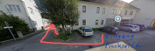 two cars parked in a parking lot in front of a building at Apartment, 3375 Krummnußbaum an der Donau in Krumnussbaum an der Donauuferbahn