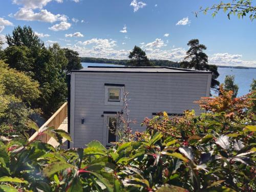 a tiny house on the shore of a lake at New lakehouse - amazing sea view and private pier! in Stockholm