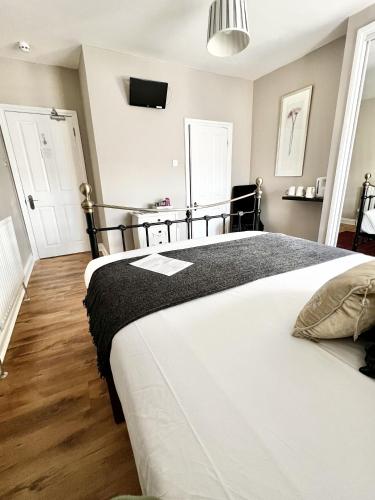 Ένα ή περισσότερα κρεβάτια σε δωμάτιο στο Devon House Guest House