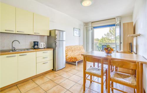 a kitchen with a table and a refrigerator at Summertime in Bibione