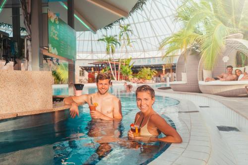 two people in the swimming pool at a resort at Hotel Nummerhof in Erding