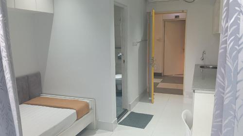 a small room with a bed and a bathroom at Smart Connect in Kolkata