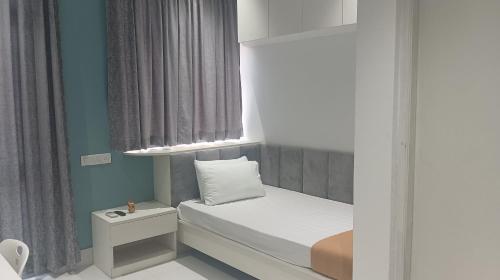 a small bedroom with a bed with a window at Smart Connect in Kolkata