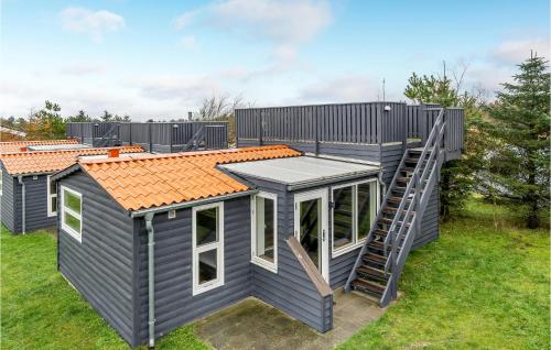 a tiny house with a staircase on the side of it at Beautiful Home In Hanstholm With Wifi in Hanstholm