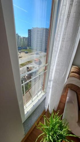 a balcony with a window with a view of a city at Street C apartment nr 1 in Pristina
