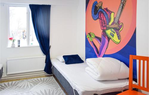 a bedroom with a mural of a woman playing a guitar at Nice Home In Orrefors With Jacuzzi in Orrefors