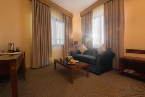 a living room with a couch and a table at Amman Inn Boutique Hotel in Amman