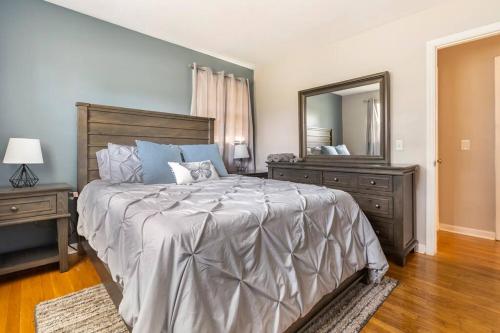 a bedroom with a large bed and a large mirror at Updated home near Fort Jackson in Columbia