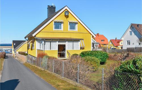 a yellow house on the side of a road at Nice Home In Sölvesborg in Sölvesborg