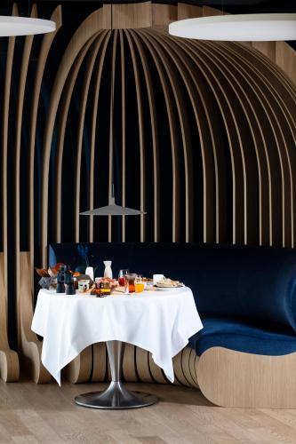 a table with food on it in a room at Hôtel & Restaurant Origines par Adrien Descouls - Teritoria in Issoire
