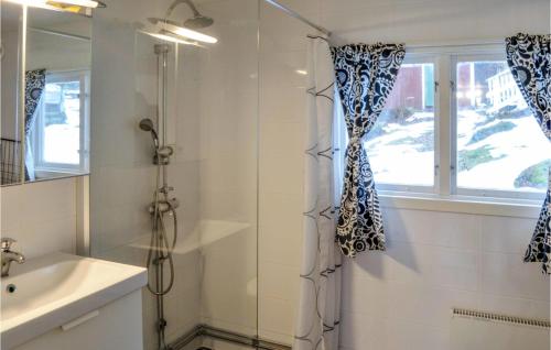 a bathroom with a shower and a sink and a window at Beautiful Home In Sdertlje With Kitchen in Södertälje